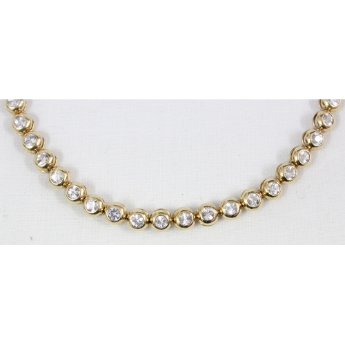 1133 - A 14ct gold mounted tennis bracelet set with 28 cut white stones (believed to be diamonds) in bubble... 