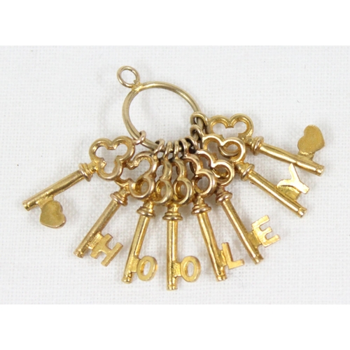 1143 - 9ct gold charm formed as a bunch of 8 trefoil shaped keys on keyring, Birmingham 1969, approx 3.45g ... 