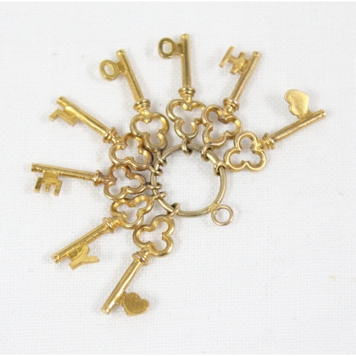 1143 - 9ct gold charm formed as a bunch of 8 trefoil shaped keys on keyring, Birmingham 1969, approx 3.45g ... 