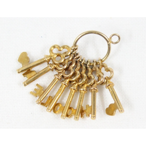 1143 - 9ct gold charm formed as a bunch of 8 trefoil shaped keys on keyring, Birmingham 1969, approx 3.45g ... 