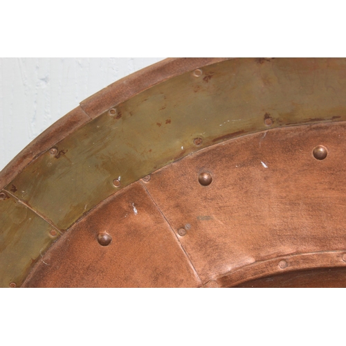 1841 - A large industrial style riveted copper wall charger, approx 80cm diameter