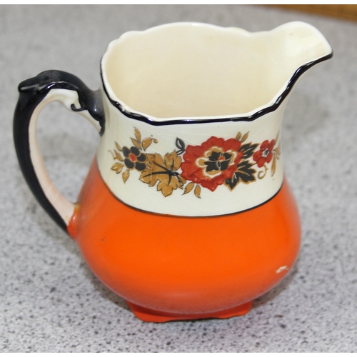 1847 - An Art Deco period orange, black and floral part coffee set by Wedgwood, Richelieu pattern