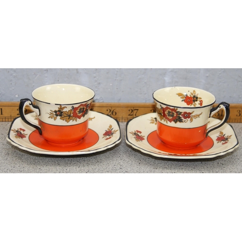 1847 - An Art Deco period orange, black and floral part coffee set by Wedgwood, Richelieu pattern