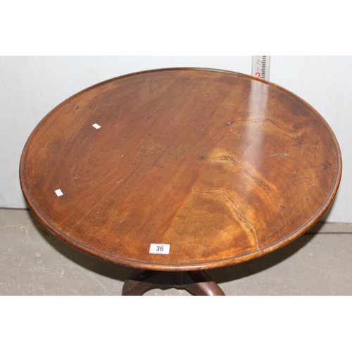 70 - A George III mahogany tilt top tripod table with dished top raised on turned column