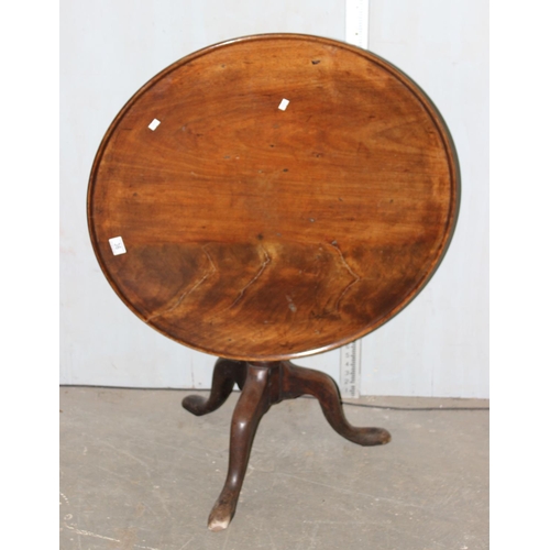 70 - A George III mahogany tilt top tripod table with dished top raised on turned column