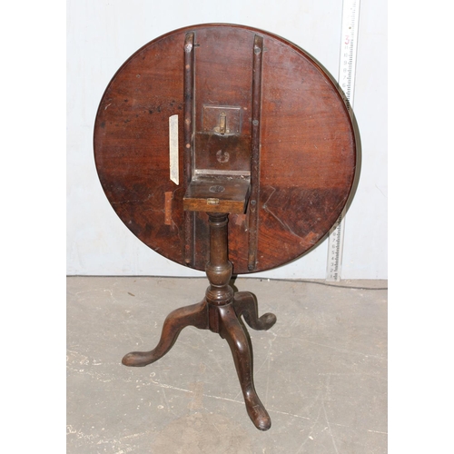 70 - A George III mahogany tilt top tripod table with dished top raised on turned column