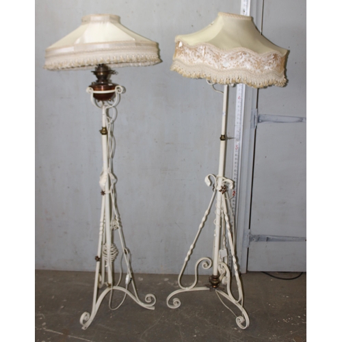 262 - A pair of antique white painted wrought iron oil lamps later converted into standard lamps with shad... 