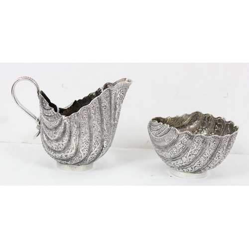 1070 - A heavy silver sugar bowl and cream jug, likely of Middle Eastern or Indian origin, unmarked but XRF... 