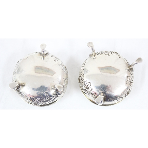 1083 - A pair of silver salts with embossed floral decoration, Birmingham 1904, makers mark rubbed, approx ... 