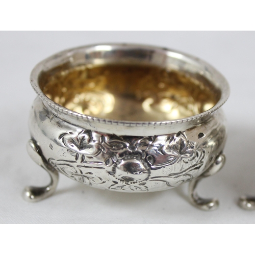 1083 - A pair of silver salts with embossed floral decoration, Birmingham 1904, makers mark rubbed, approx ... 