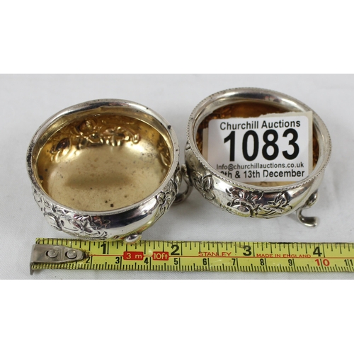 1083 - A pair of silver salts with embossed floral decoration, Birmingham 1904, makers mark rubbed, approx ... 