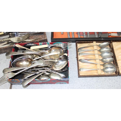 1087 - A large qty of assorted silver plate and stainless steel cutlery, some boxed