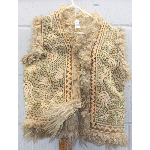 212 - A vintage Afghan embroidered sheepskin waistcoat