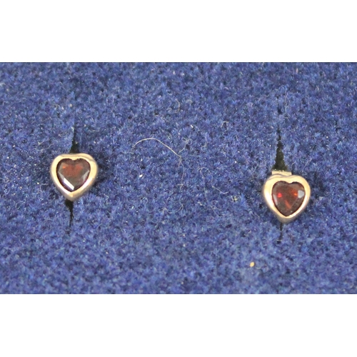 1199E - A pair of heart shaped 9ct gold and garnet stud earrings