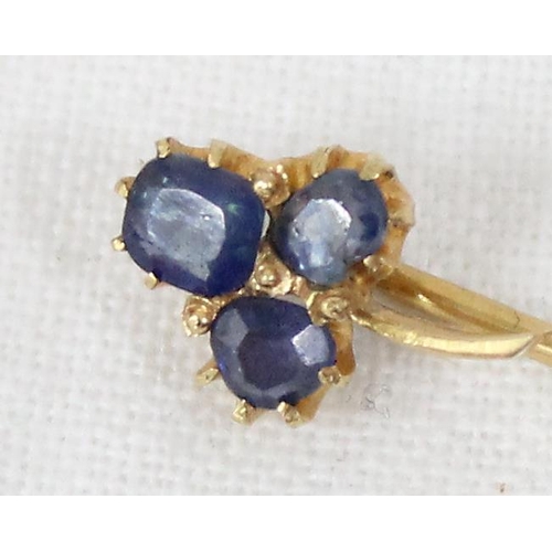 1199I - An antique 15ct gold stick pin formed as a 3 leaf shamrock from blue stones, possibly sapphires, unm... 