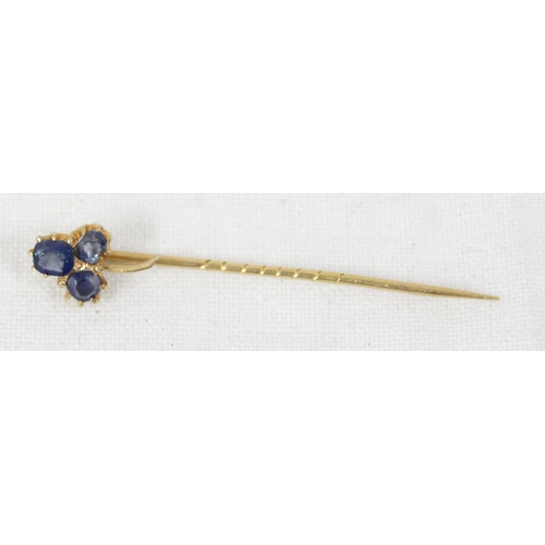 1199I - An antique 15ct gold stick pin formed as a 3 leaf shamrock from blue stones, possibly sapphires, unm... 