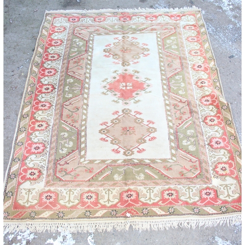 203 - A large colourful Turkish wool rug, approx 350cm x 255cm