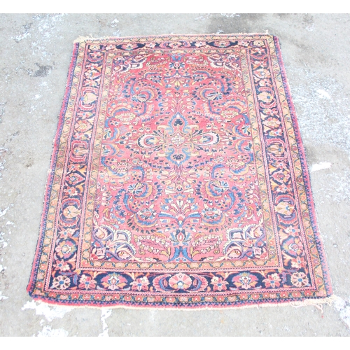 205 - A large vintage decorative red ground rug, approx 200cm x 154cm