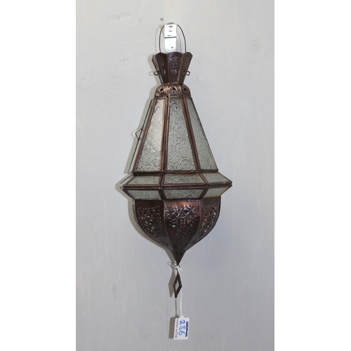 236 - A metal and glass Moroccan style hanging lantern or light