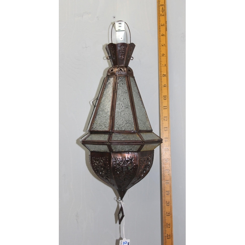 236 - A metal and glass Moroccan style hanging lantern or light