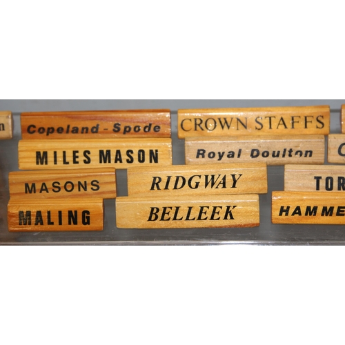 1650B - A large qty of wooden display name plaques naming famous ceramics factories, ideal for antique centr... 