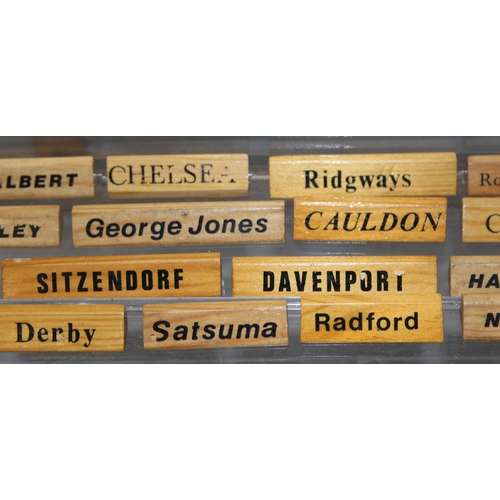 1650B - A large qty of wooden display name plaques naming famous ceramics factories, ideal for antique centr... 