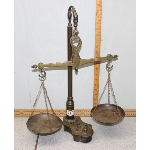 747 - A set of antique brass balance beam apothecary scales with weights inset into base, cross beam marke... 