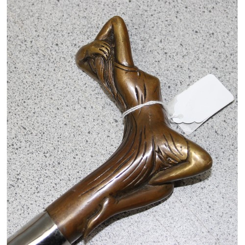 1600 - An Art Deco style brass handled walking stick, the handle formed as a scantily clad lady