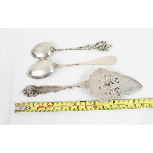 1014 - An 830 silver decorative cake slice, a similar 800 silver spoon and a Canadian silver and enamel spo... 