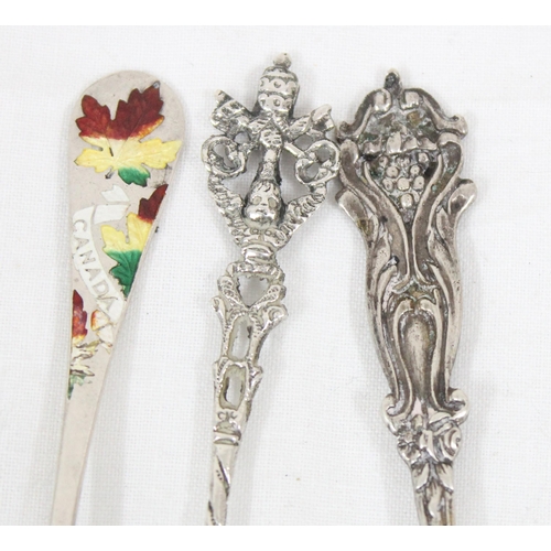 1014 - An 830 silver decorative cake slice, a similar 800 silver spoon and a Canadian silver and enamel spo... 