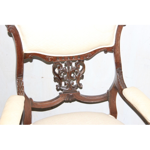 11 - A pair of Victorian armchairs with carved details and stuffed seats and backs