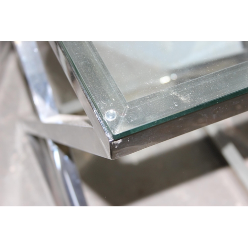 15 - A pair of designer style X frame chrome and glass side tables, the chrome base mounted with a clear ... 