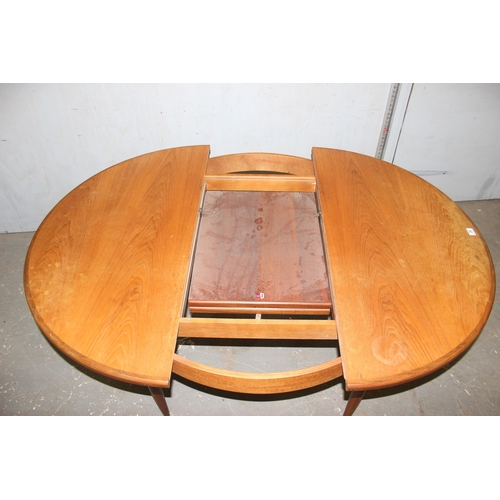 20 - A retro G-Plan teak extending round/ oval dining table and a set of 4 round seated bar backed chairs... 