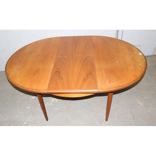 20 - A retro G-Plan teak extending round/ oval dining table and a set of 4 round seated bar backed chairs... 