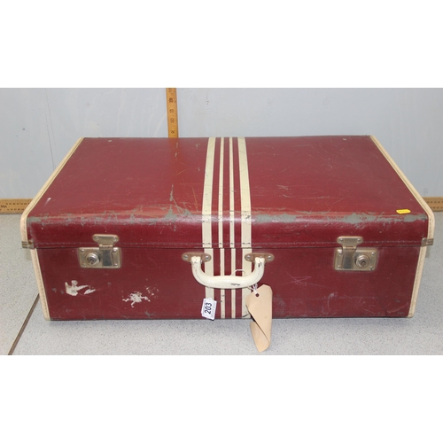 203 - A large vintage suitcase containing linen and other various fabrics etc