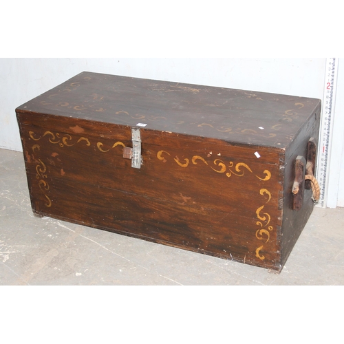 23 - A large vintage painted wooden trunk with rope handles, approx 123cm wide