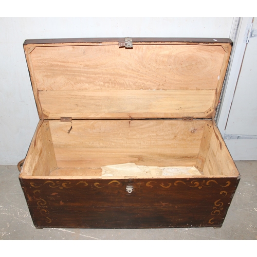 23 - A large vintage painted wooden trunk with rope handles, approx 123cm wide