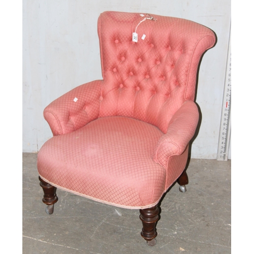 32 - An antique pink upholstered nursing chair with button back and turned legs