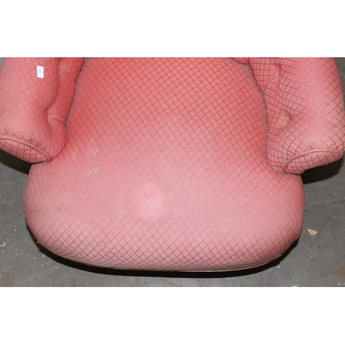 32 - An antique pink upholstered nursing chair with button back and turned legs