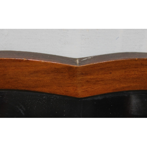 359 - A vintage cloud shaped walnut framed wall mirror with bevelled glass