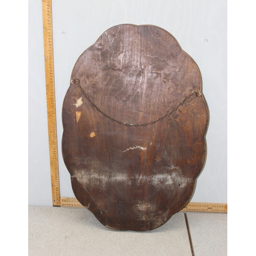 359 - A vintage cloud shaped walnut framed wall mirror with bevelled glass