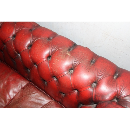 5 - A Chesterfield Ox-Blood red 2 seater button back sofa