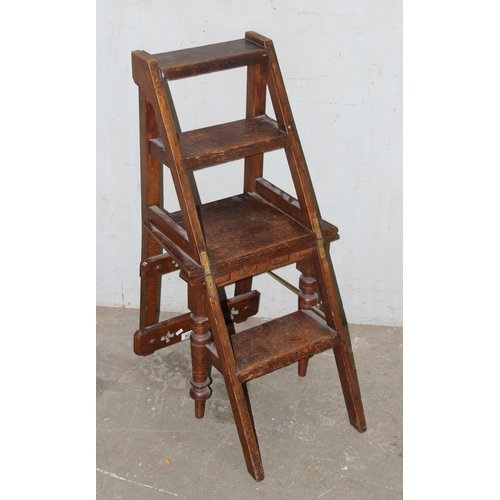 56 - A late 19th or early 20th century metamorphic oak library step chair in the Gothic revival taste, th... 