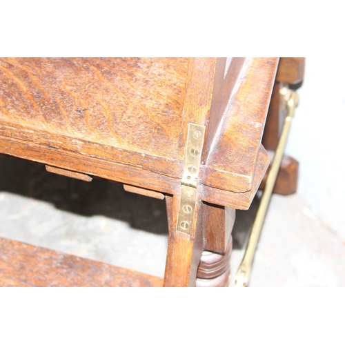 56 - A late 19th or early 20th century metamorphic oak library step chair in the Gothic revival taste, th... 