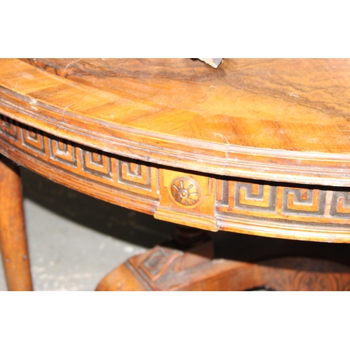 58 - An antique round dining table, likely Continental with impressive carved base and Greek Key carved f... 