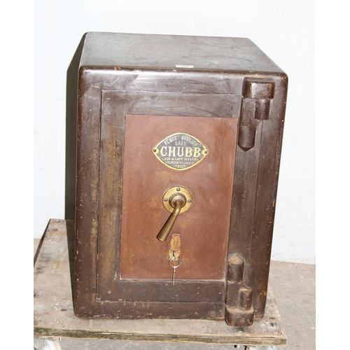 60 - An antique Chubb of London painted cast iron safe and key, the interior with full livery including R... 