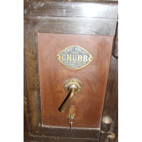 60 - An antique Chubb of London painted cast iron safe and key, the interior with full livery including R... 