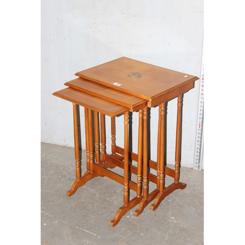 69 - A 20th century nest of tables with marquetry inlay