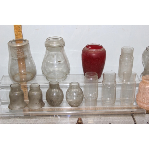 251 - A large qty of vintage oil lamp and other glass shades, chimneys and hangers