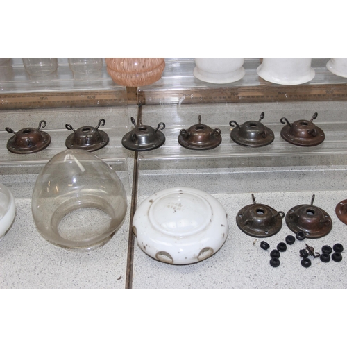 251 - A large qty of vintage oil lamp and other glass shades, chimneys and hangers